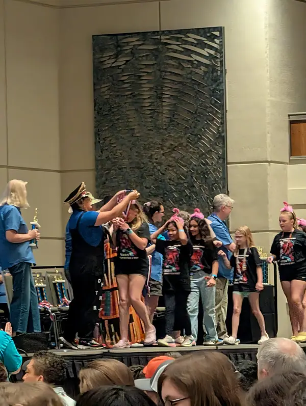 Team receiving medals on stage