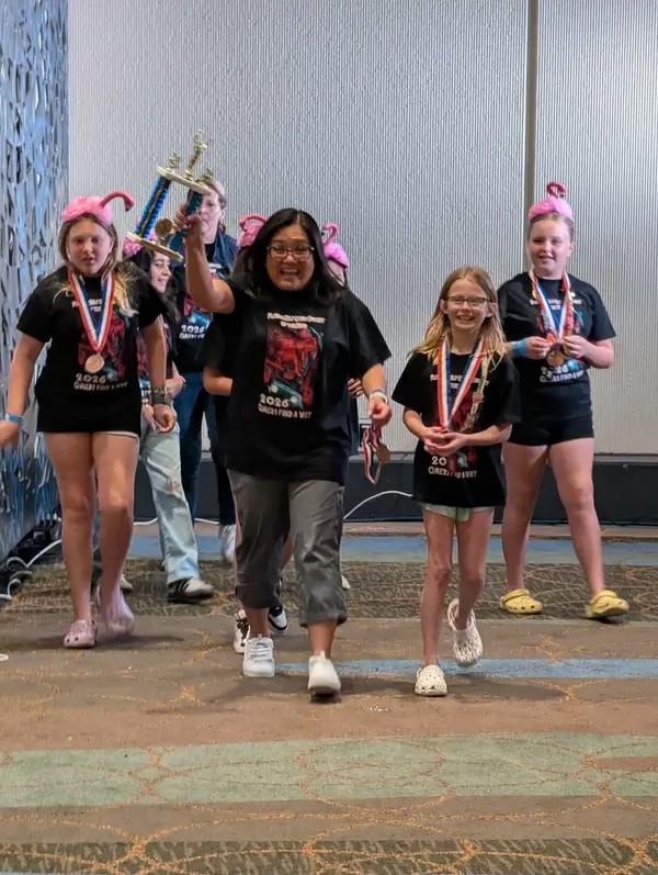 Team walking proudly with trophy